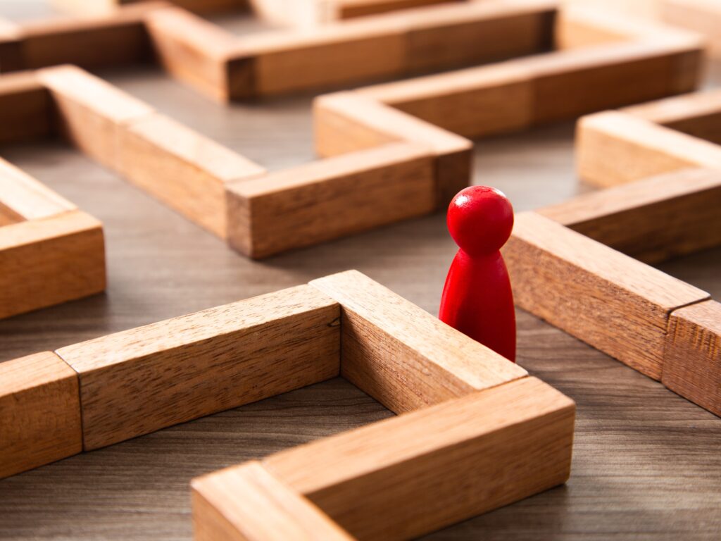 Conceptual image of a person lost in a labyrinth representing the 5 biggest blind spots in retail transformation that every CEO should know.